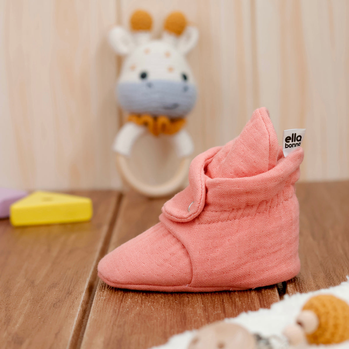 Single bootie on a tabletop, wider side view.