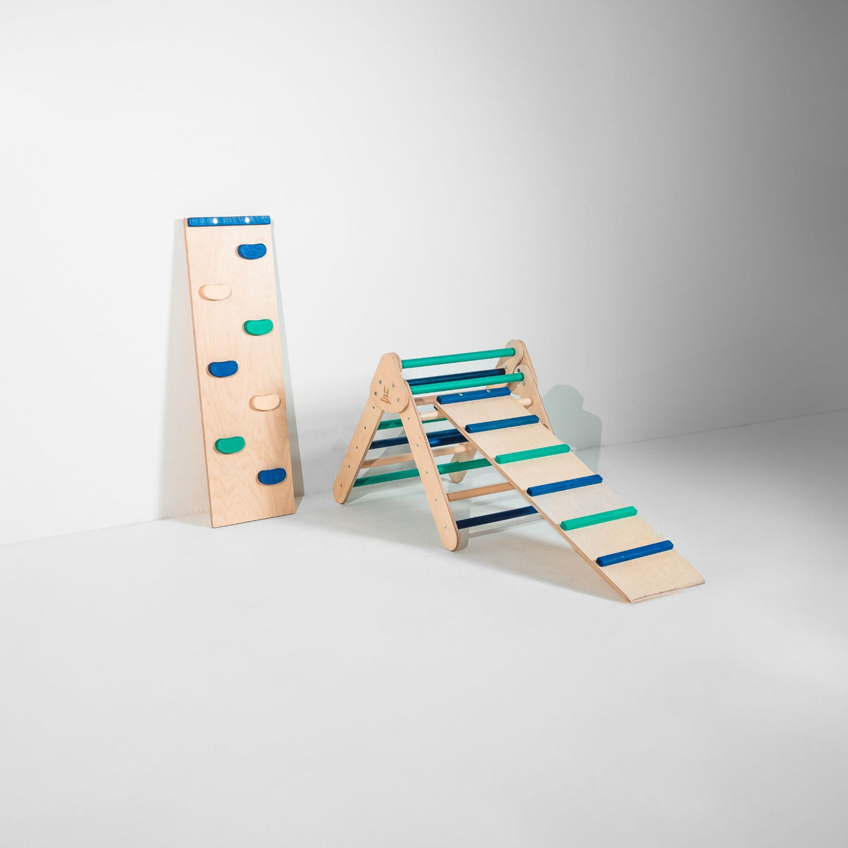 Small blue and teal triangle with attached ladder ramp and a climbing-hold ramp beside it.