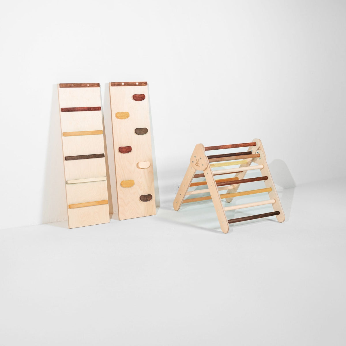 Small mixed brown and cream climbing triangle beside two upright ramps.