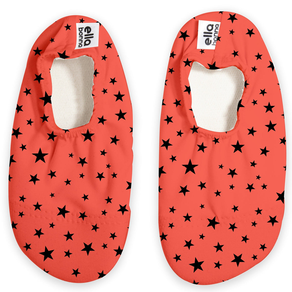 Top view of a pair of coral red slip-on water shoes with black star print on a white background.