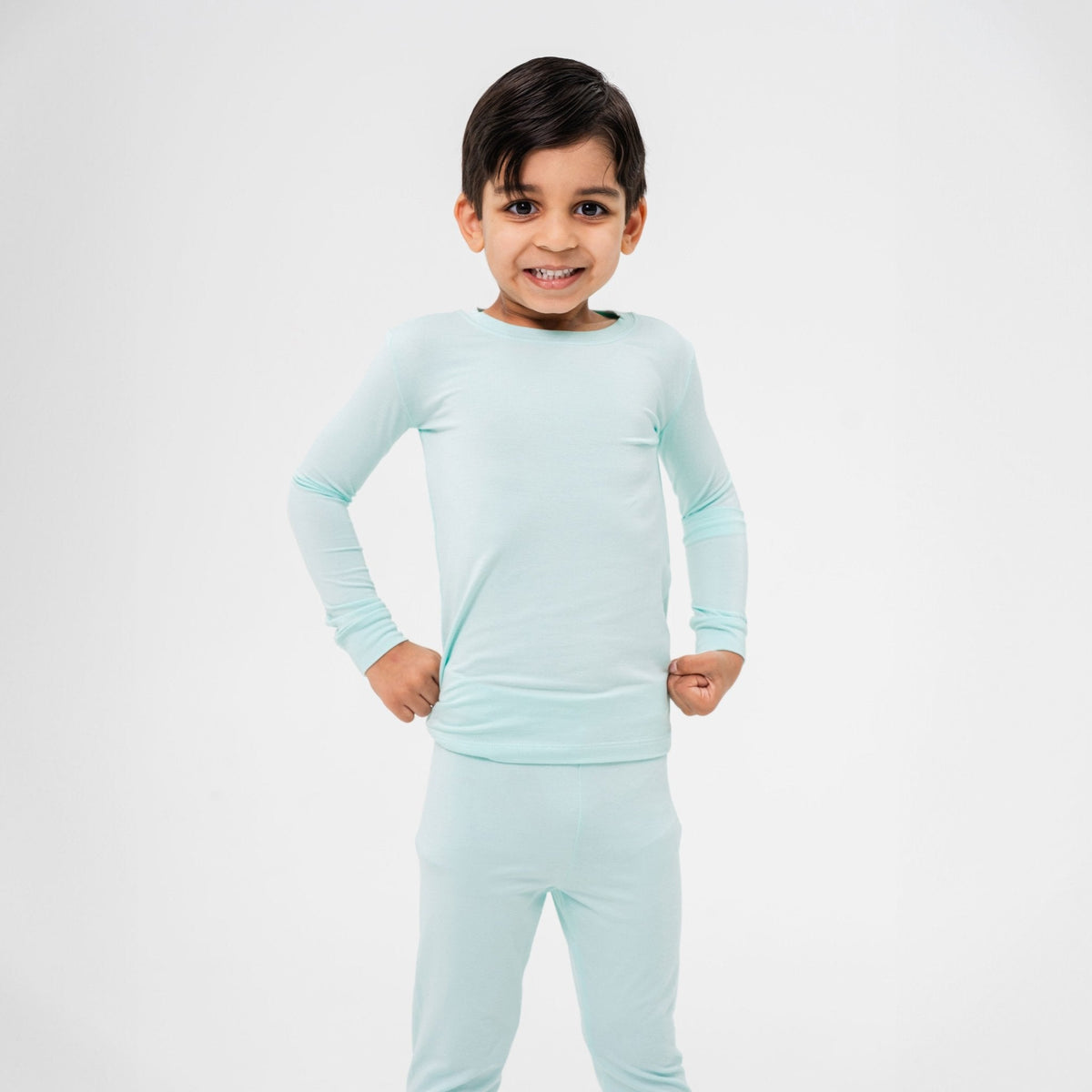 Child standing with hands at the waist in Bam & Stitch Ocean Breeze Long Sleeve Pajamas.