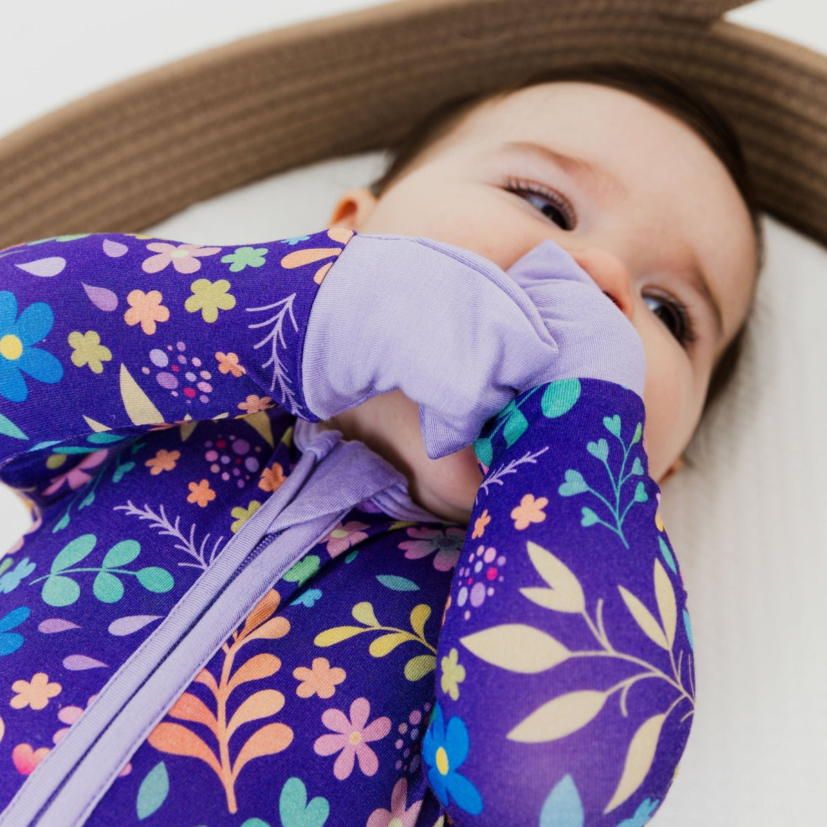 Baby wearing Bam & Stitch Orchid Gardens Convertible Romper, showing a fold-over hand covering.