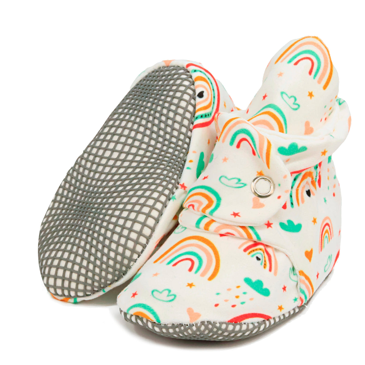 Cream baby booties with colorful rainbows and snap straps, with one sole facing the camera on a white background.