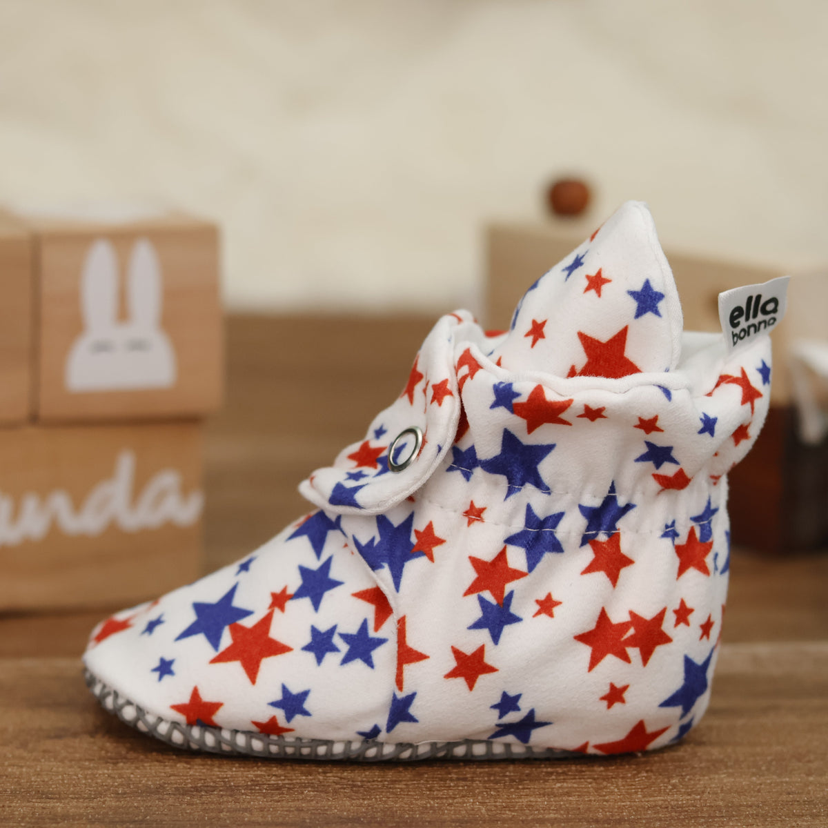 Single star-print bootie on a tabletop, close side view.