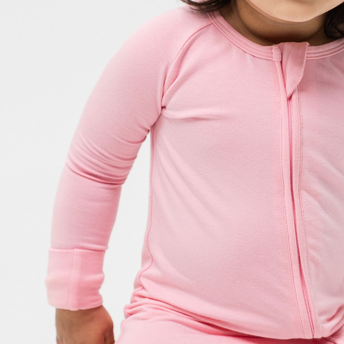 Close-up of the front zipper and fabric on Bam & Stitch Pink Blossom Convertible Romper.