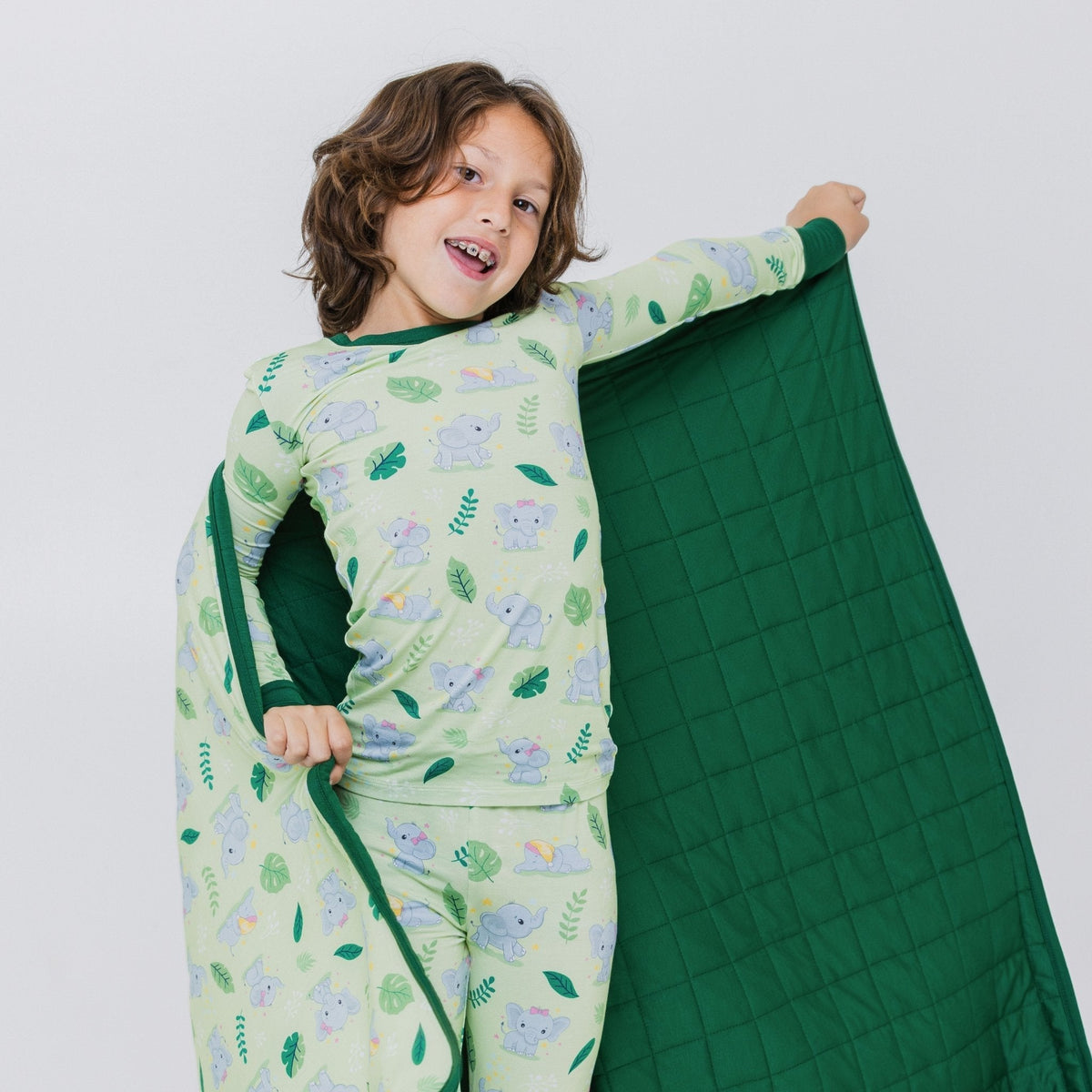 Child holding Bam & Stitch Playfully Strong Blanket open to show both sides.