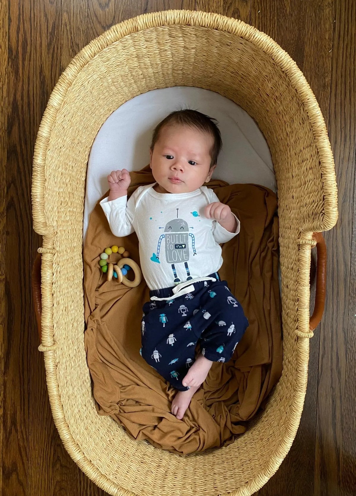 Lifestyle photo showing a wood and silicone teether with a child