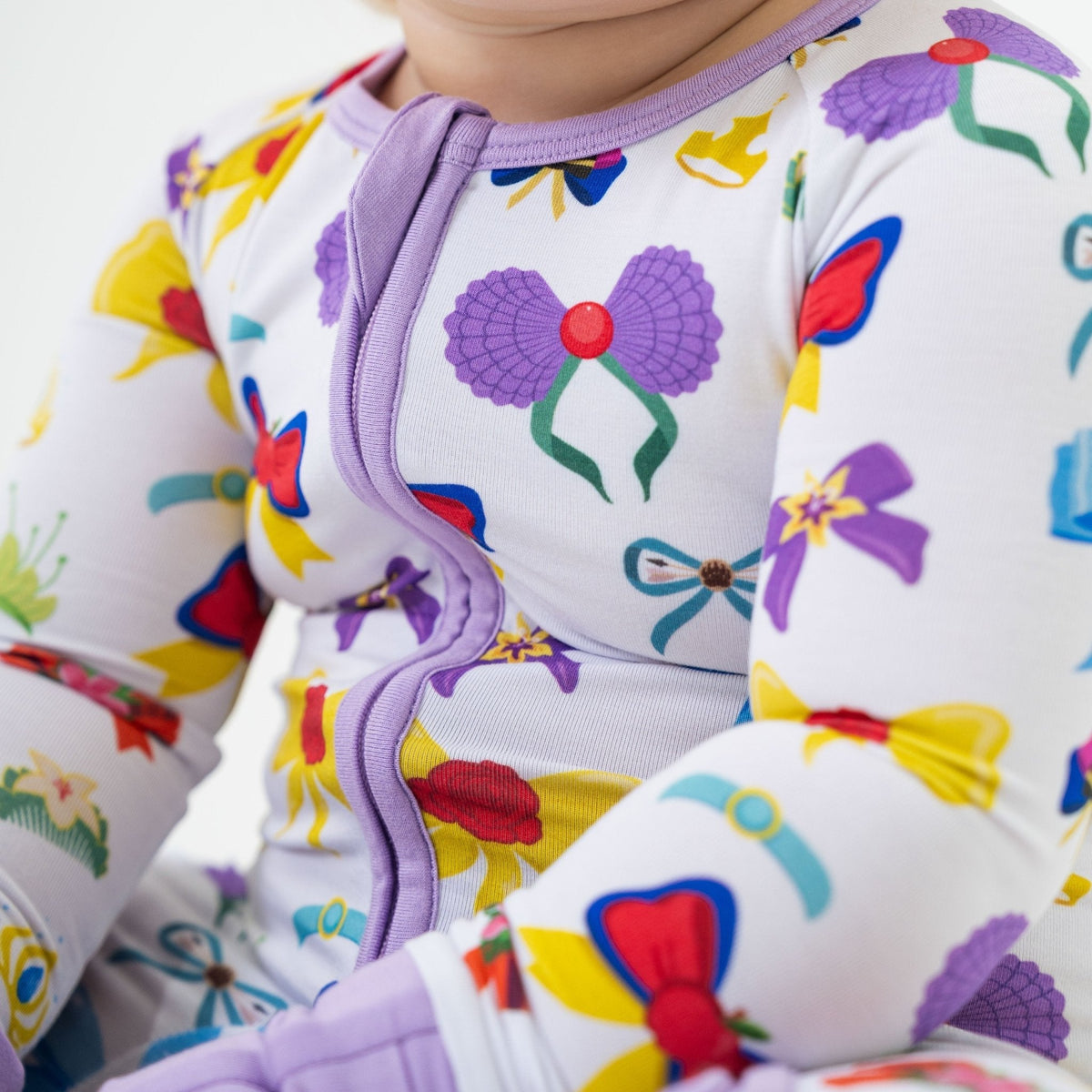 Close-up of the front zipper and fabric on Bam & Stitch Sparkle & Reign Convertible Romper.