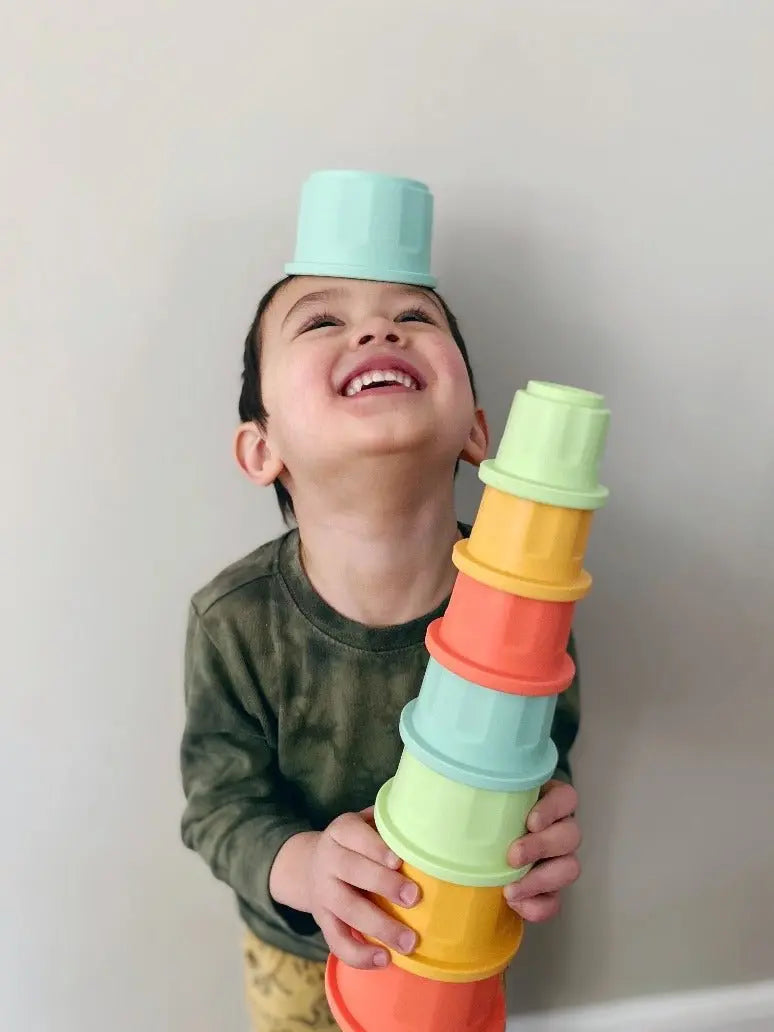 Lifestyle photo showing silicone stacking toys with a child