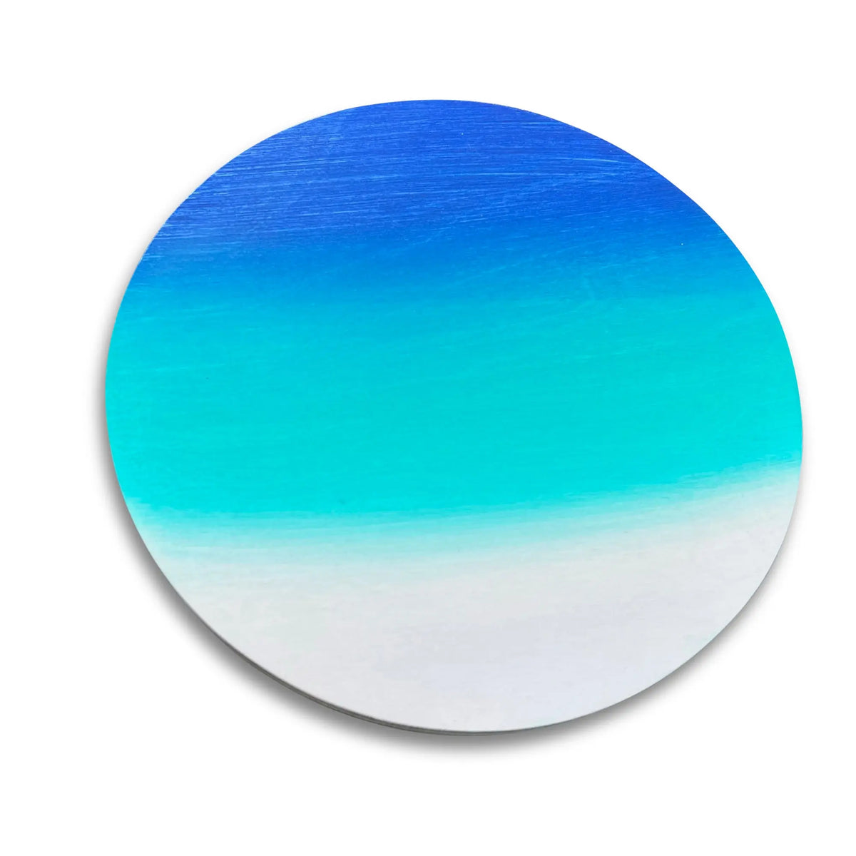 Close-up of a round stepping stone with a blue, teal and white gradient.