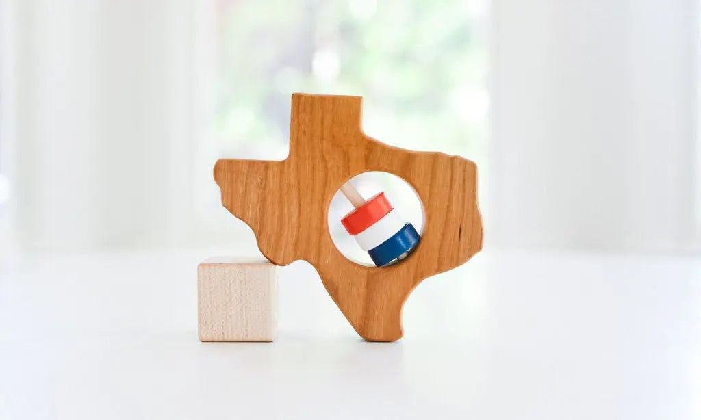 Bannor Toys Texas State Wooden Baby Rattle, showing state-shaped cherry-wood body and colored rattle discs
