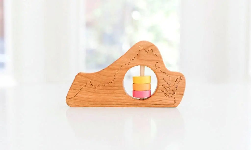 Bannor Toys Virginia State Wooden Baby Rattle, showing state-shaped cherry-wood body and colored rattle discs