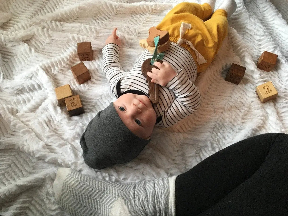Lifestyle photo showing wooden toy keys with a child
