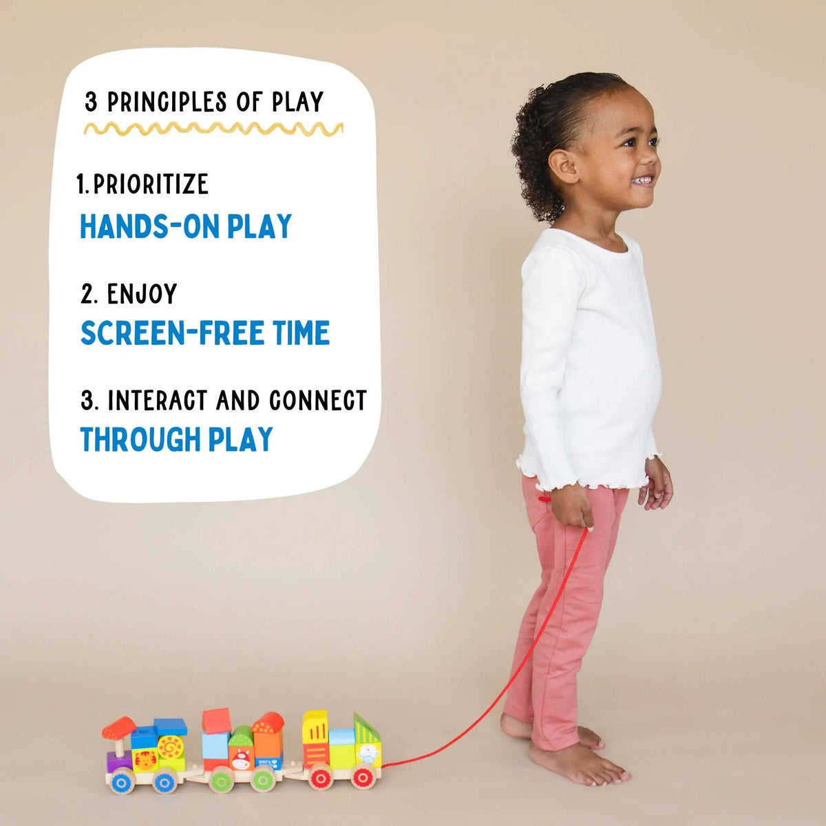 SpiritnSprout: Child standing with the train beside a hands-on-play graphic