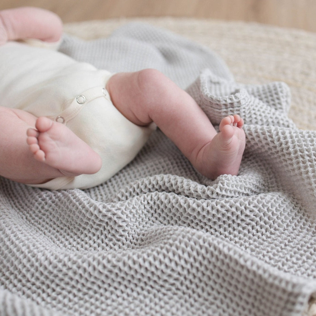 SpiritnSprout: Close-up of baby’s feet on the grey blanket