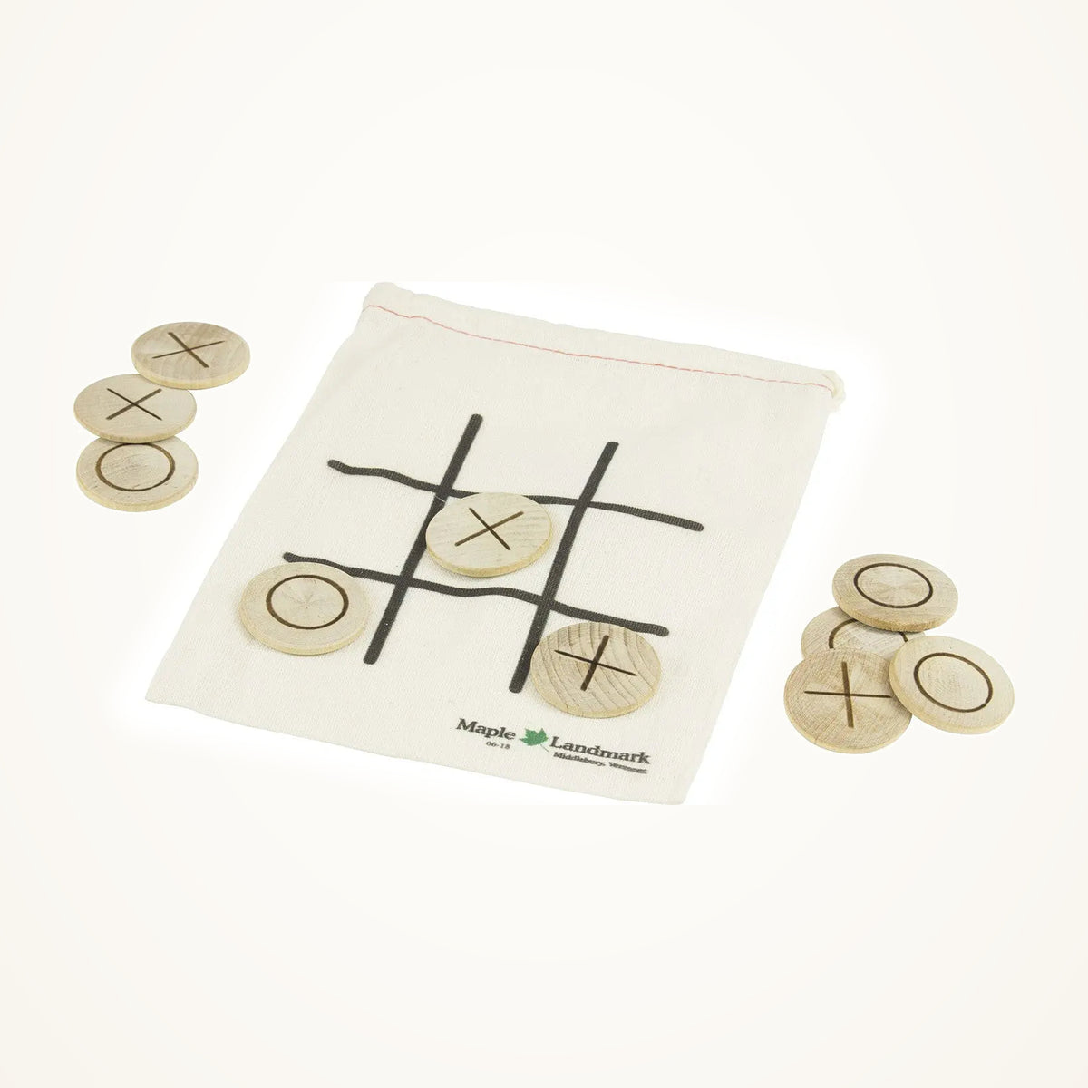 Maple Landmark Games To Go Tic-Tac-Toe Set on a warm ivory background