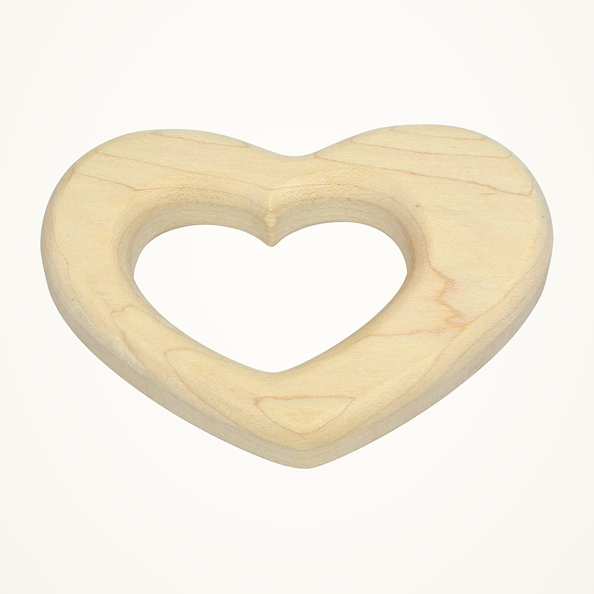 Maple Landmark Heart Shaped Baby Teether photographed on a warm ivory background.