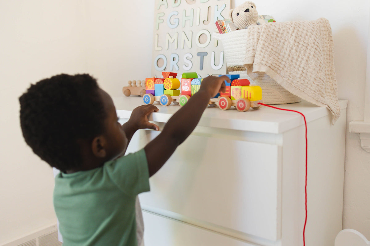 SpiritnSprout: Child arranging the train on a small table