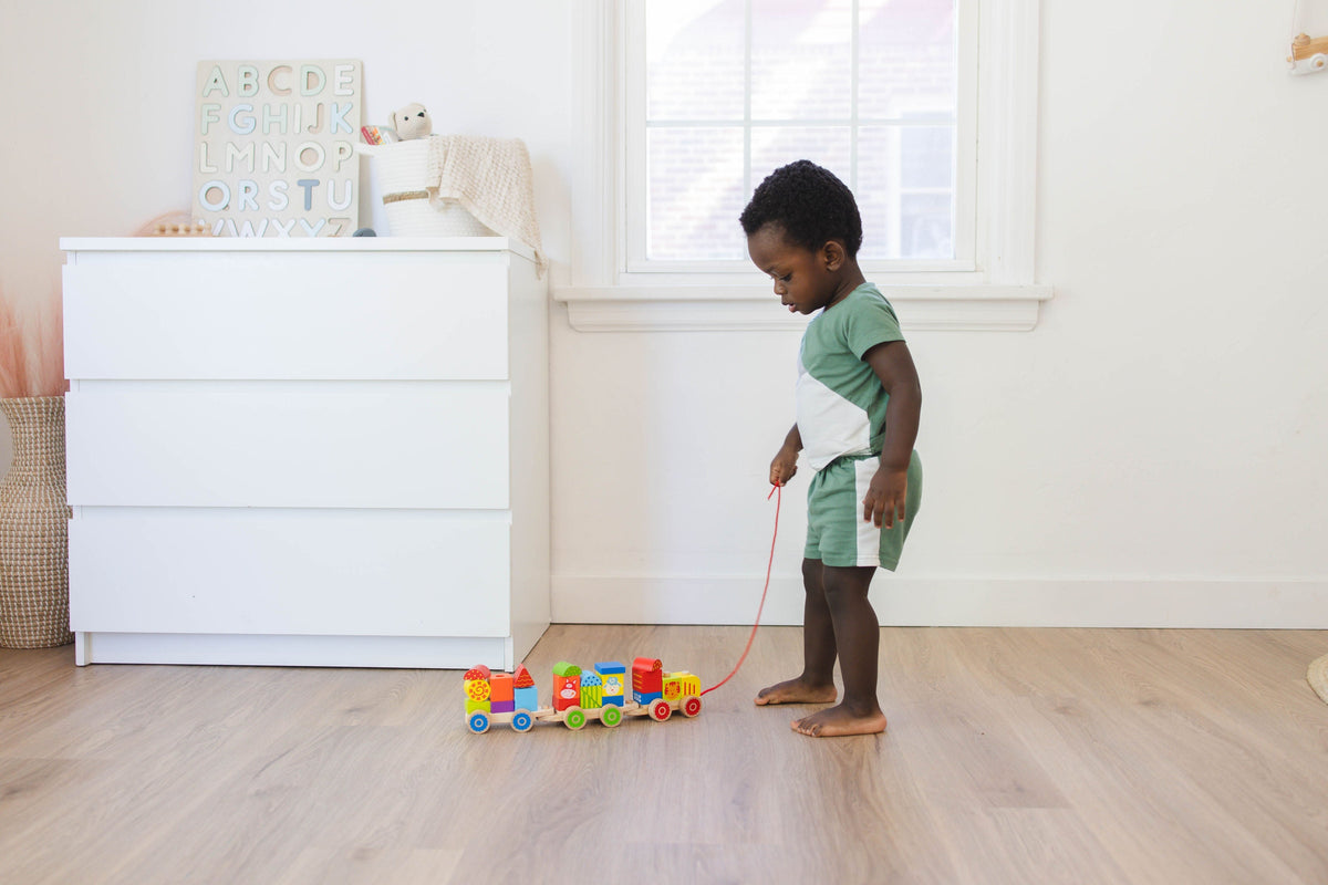 SpiritnSprout: Child pulling the assembled train across the floor