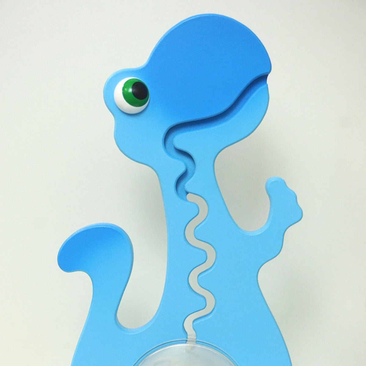 Close-up of the blue dinosaur head and front coin track