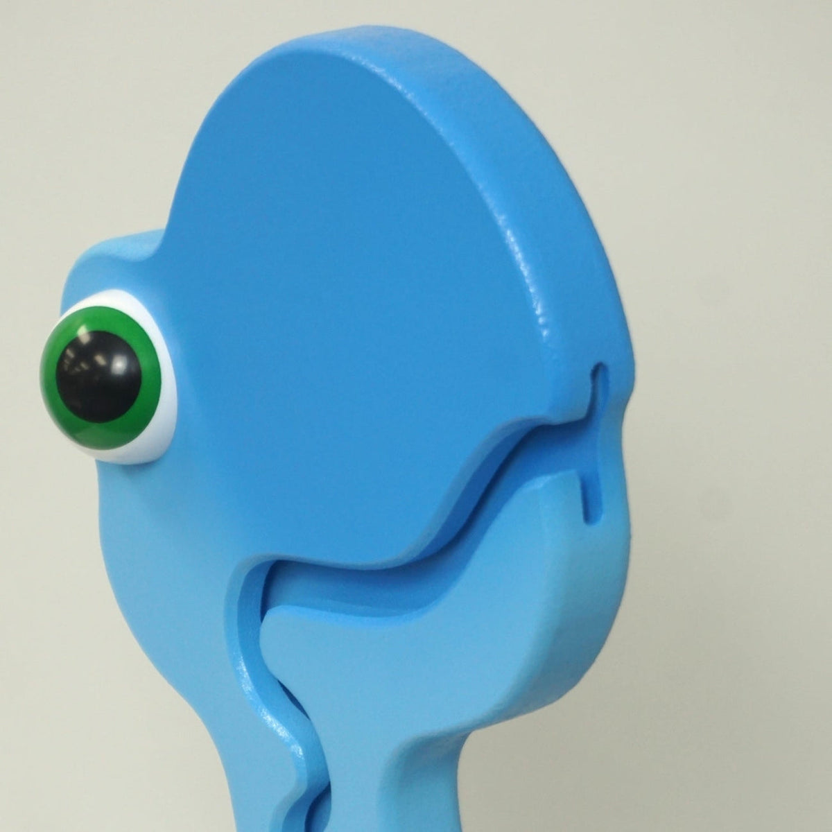 Side close-up of the blue dinosaur head and coin-entry slot