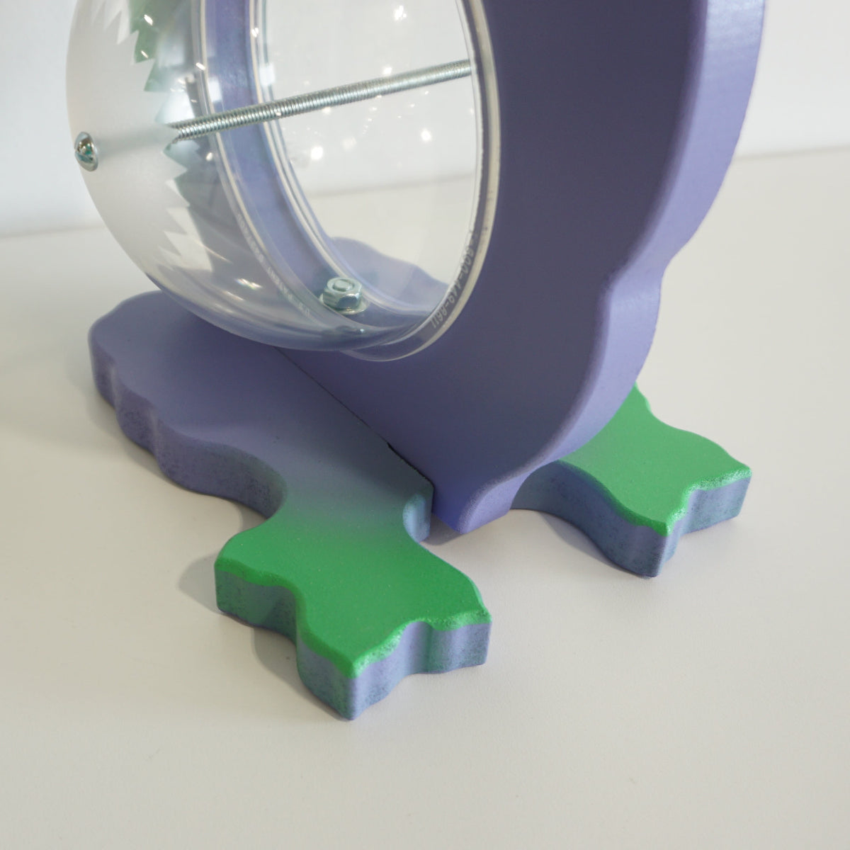 Side close-up of the dragon bank plastic belly, attachment bolt and shaped feet