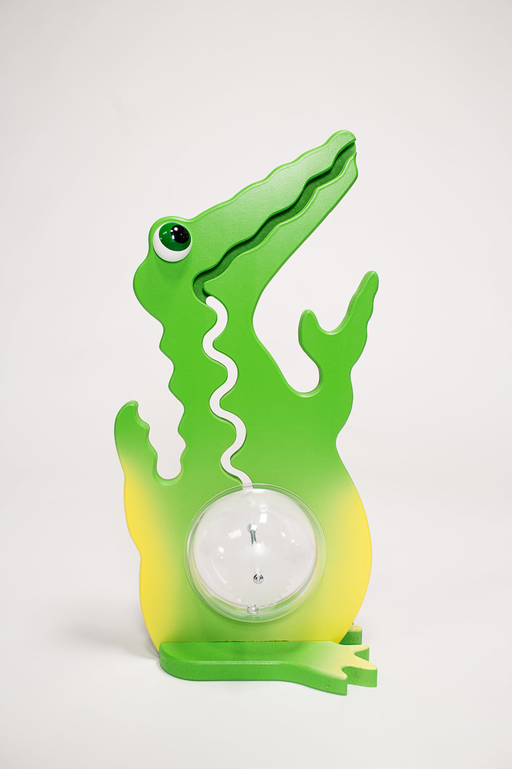 Front view of the green and yellow alligator coin bank