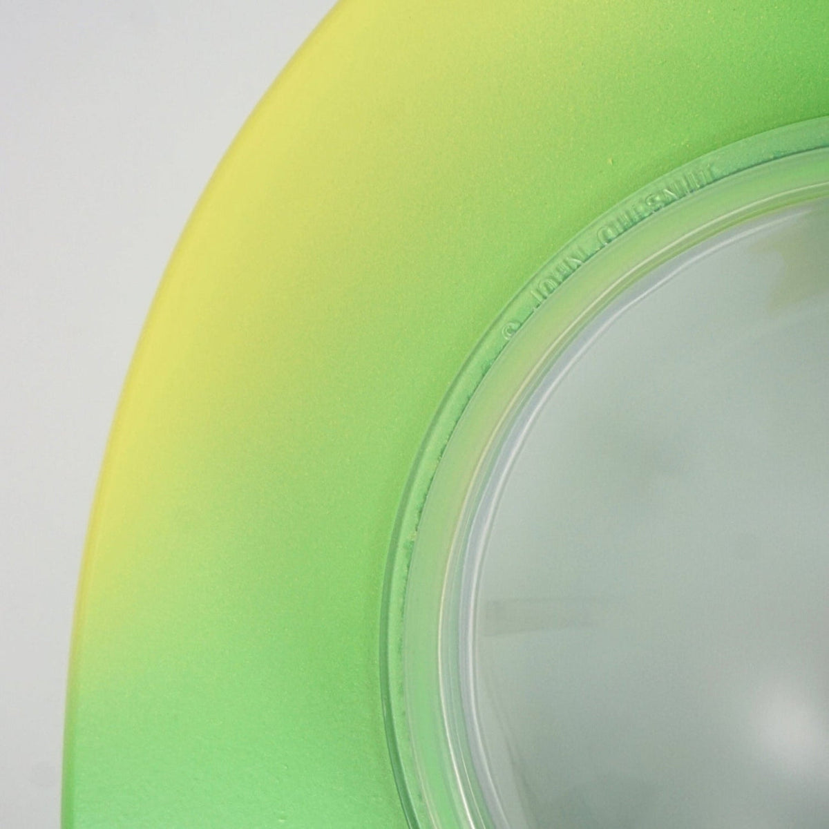 Close-up of the alligator bank blended green and yellow finish beside the clear belly