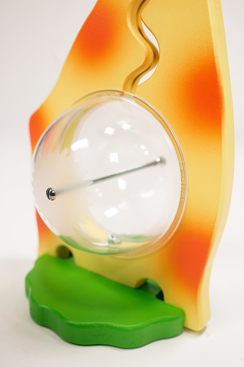Close-up of the giraffe bank clear belly, metal bolt and green base