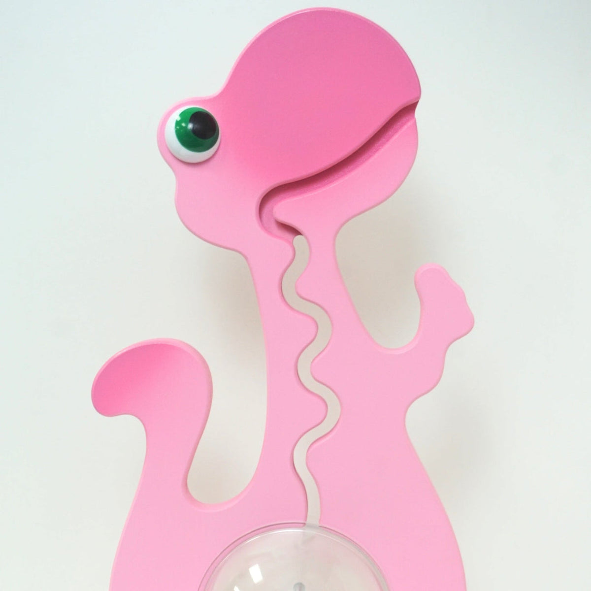 Close-up of the pink dinosaur head and front coin track