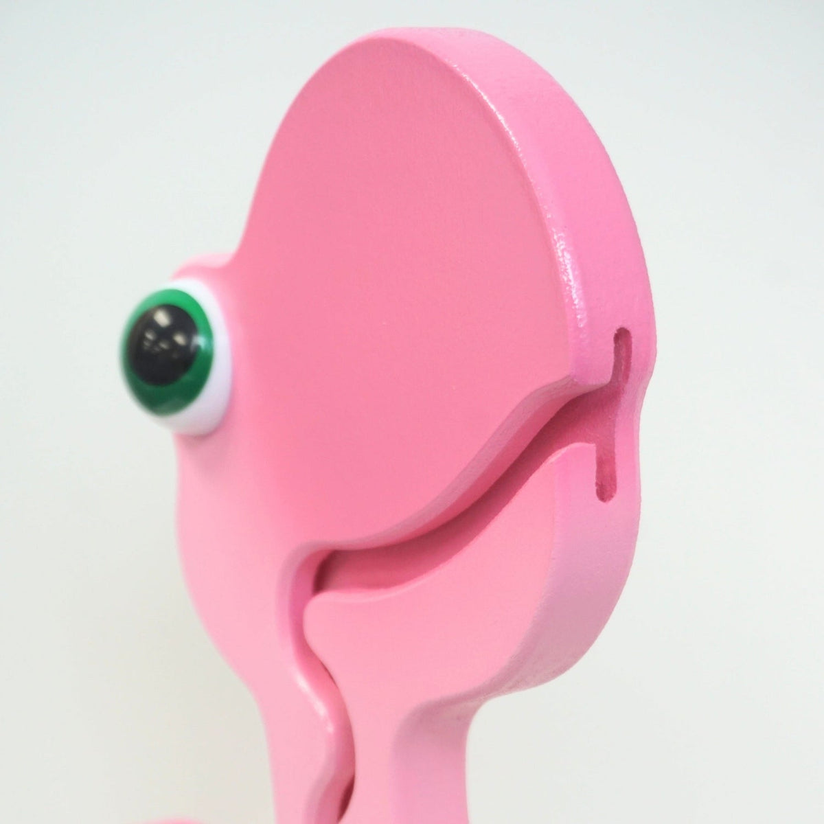 Side close-up of the pink dinosaur head and coin-entry slot