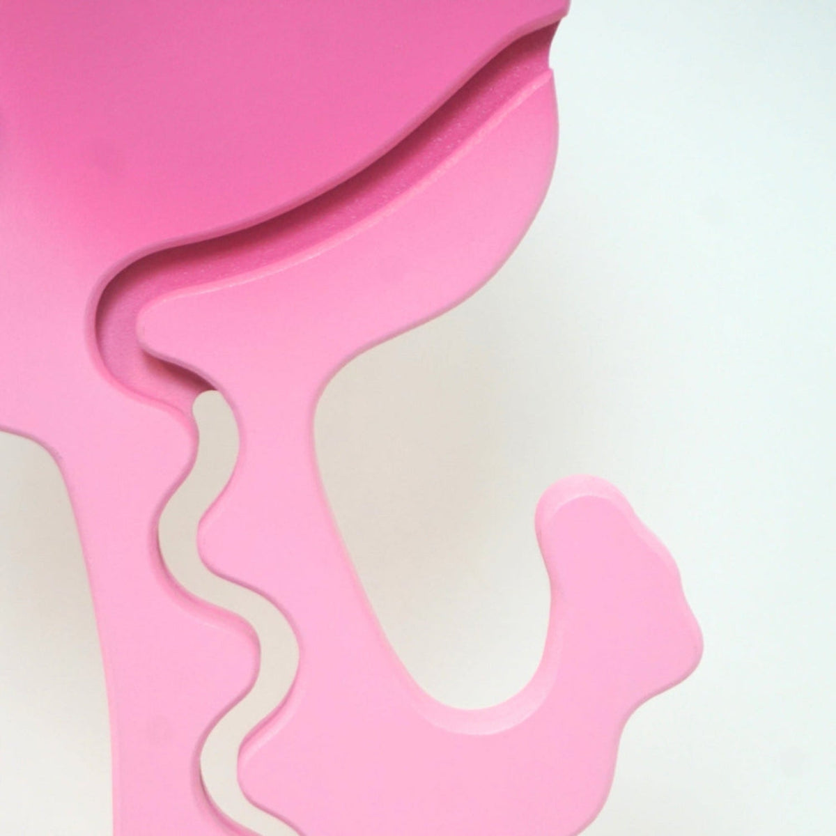 Close-up of the pink dinosaur carved zigzag coin track