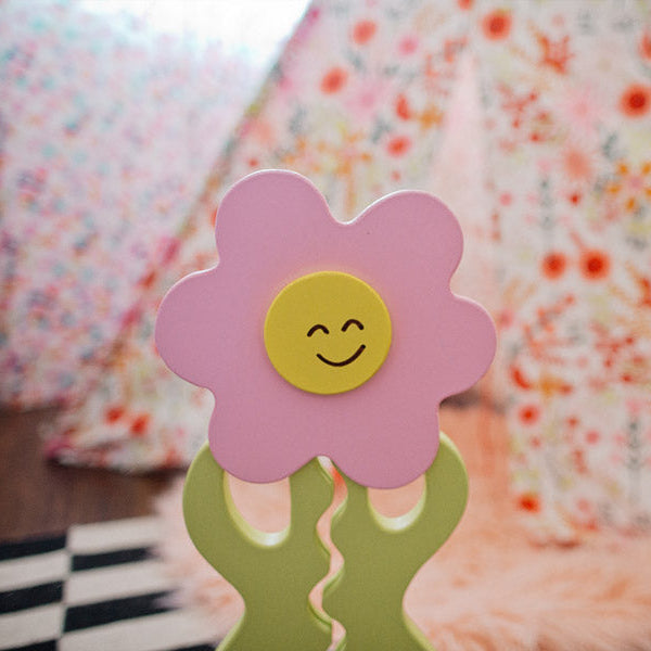Close-up of the pink flower bank face with floral fabric in the background