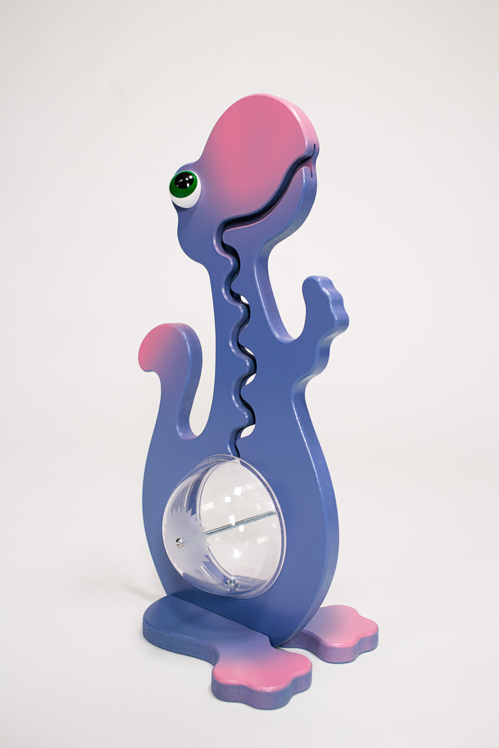 Angled view of the purple and pink dinosaur coin bank