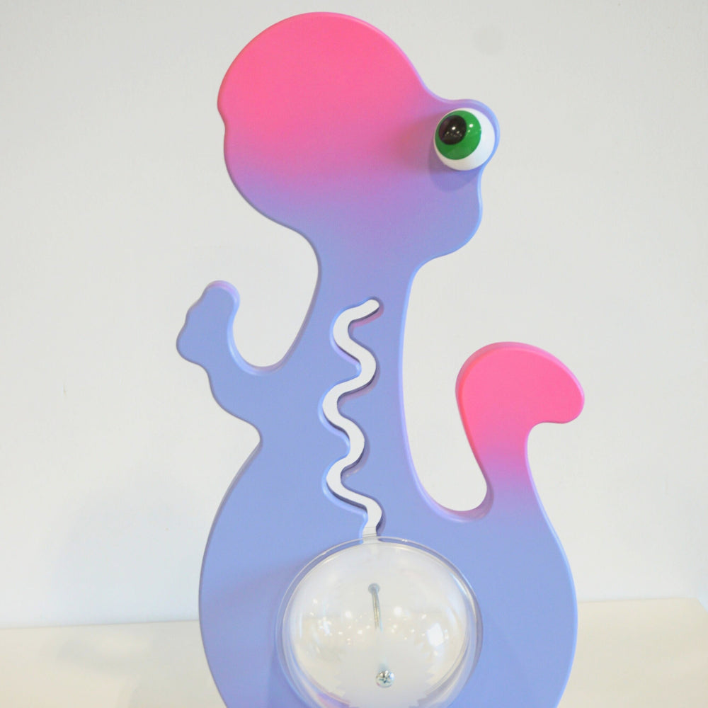 Reverse view of the purple and pink dinosaur coin bank