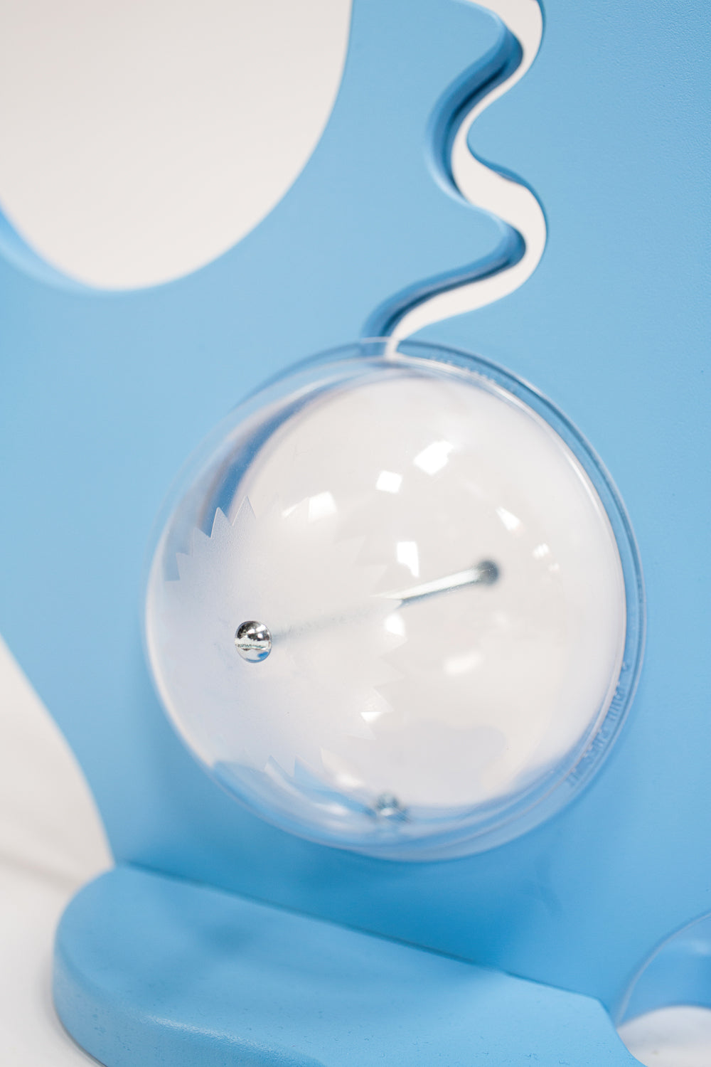 Close-up of the blue dinosaur bank clear belly, metal bolt and coin track
