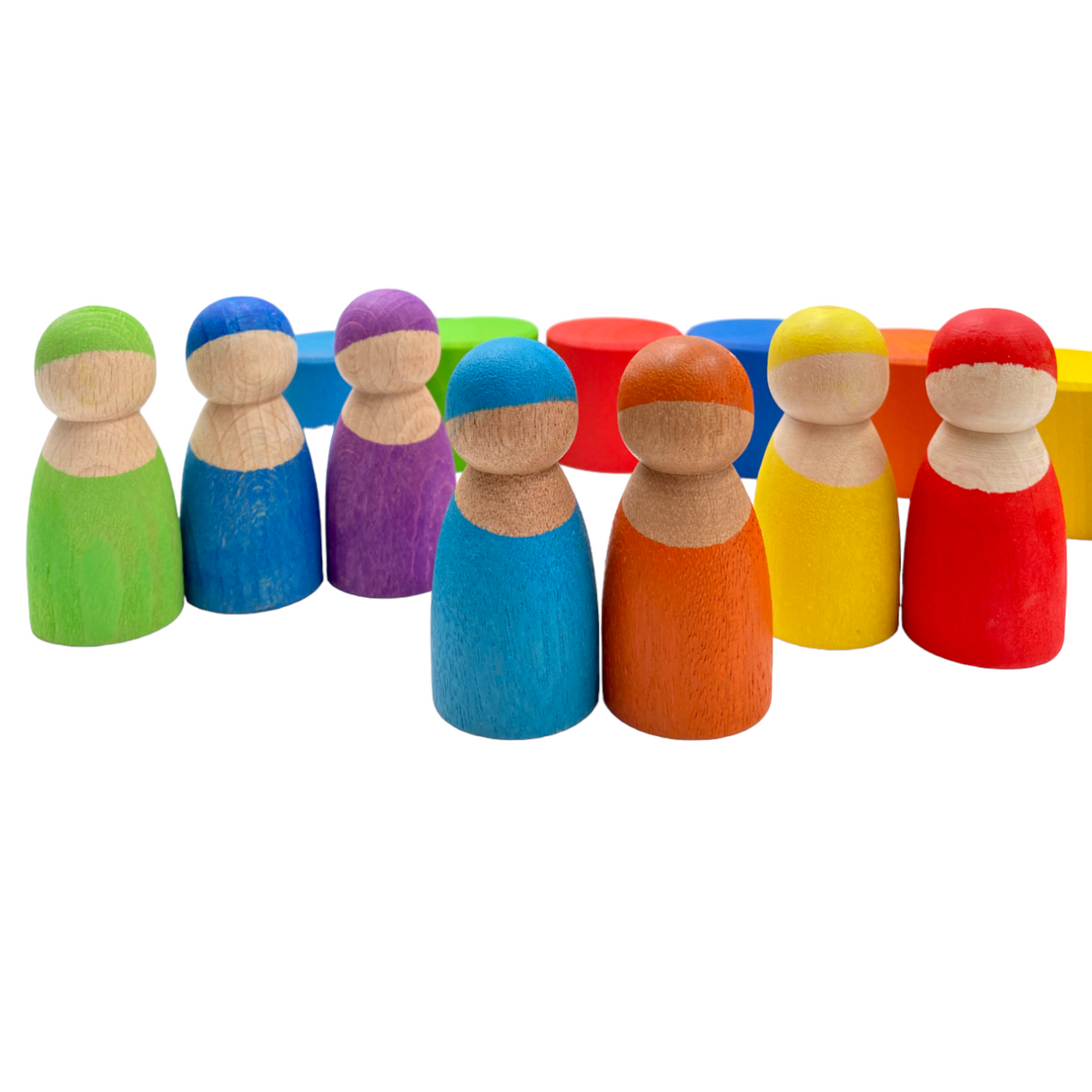 Close view of seven peg dolls showing varied natural wood tones and colored outfits