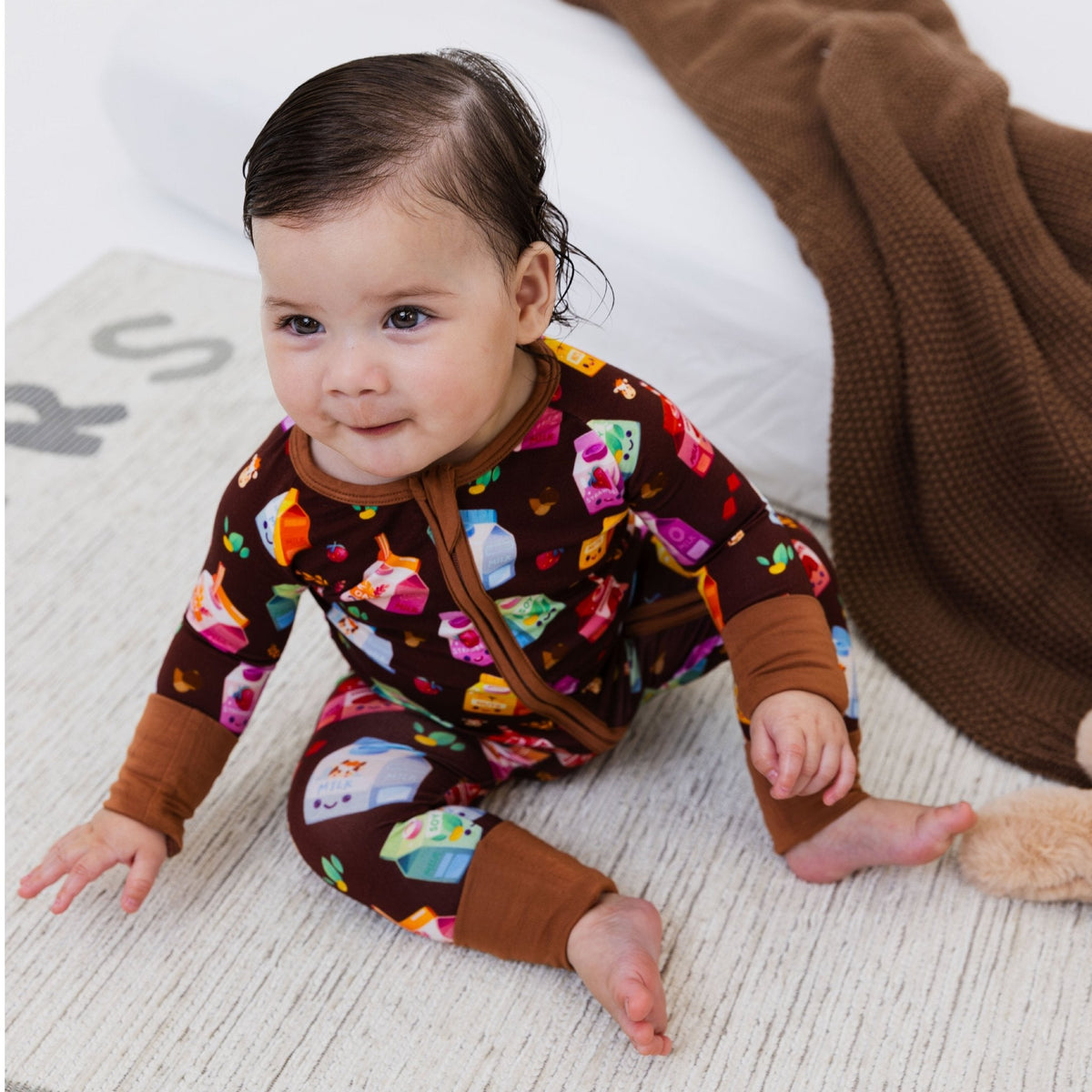 Side view of a baby crawling in Bam & Stitch All the Milks! Convertible Romper.