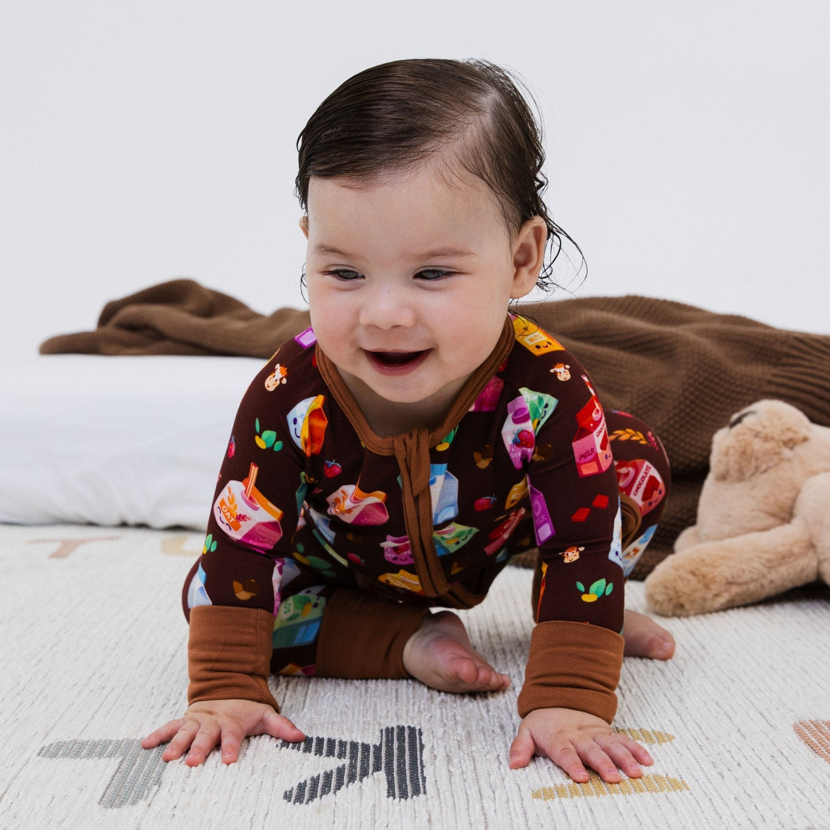 Front view of a baby crawling in Bam & Stitch All the Milks! Convertible Romper.