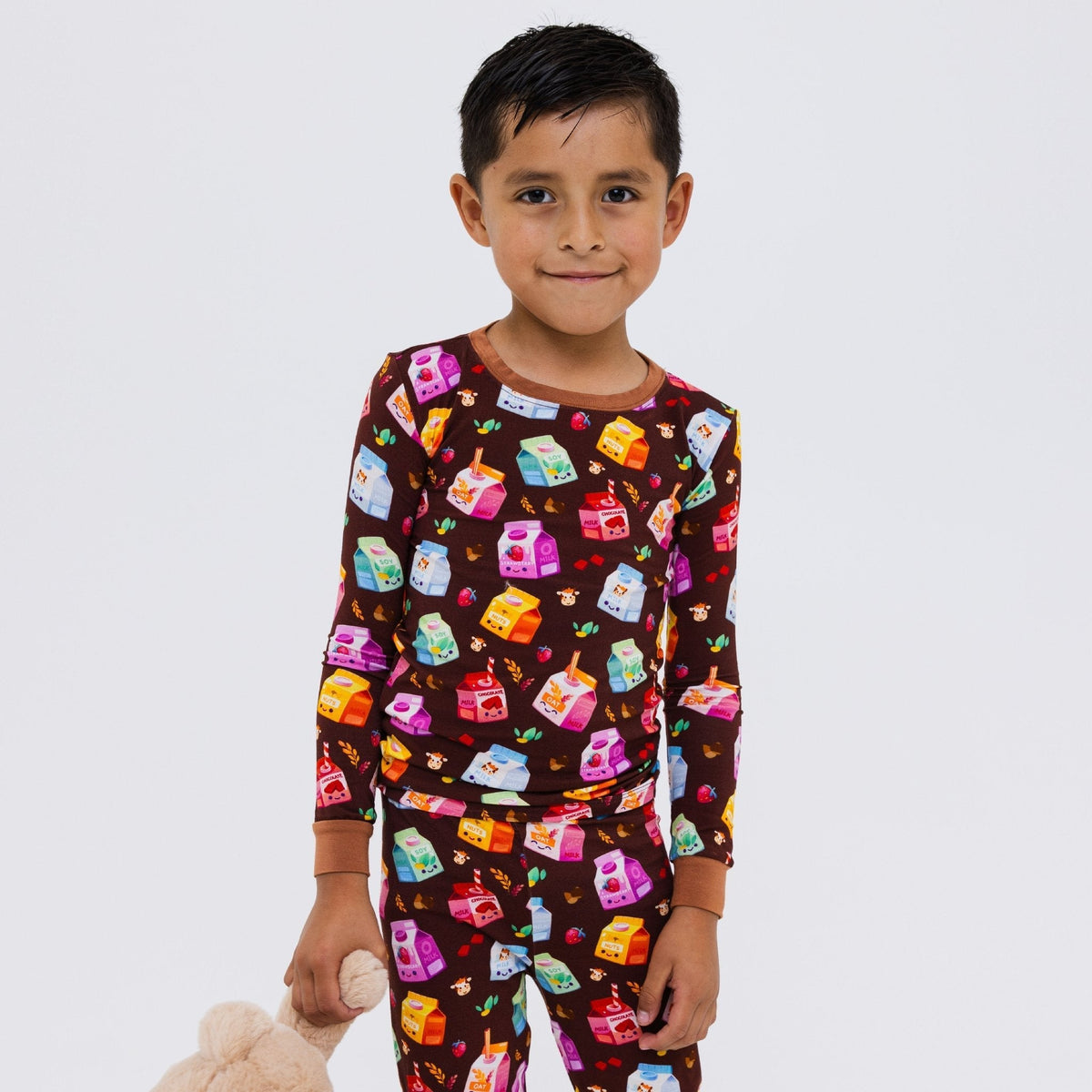 Child standing with hands behind their back in Bam & Stitch All the Milks! Long Sleeve Pajamas.