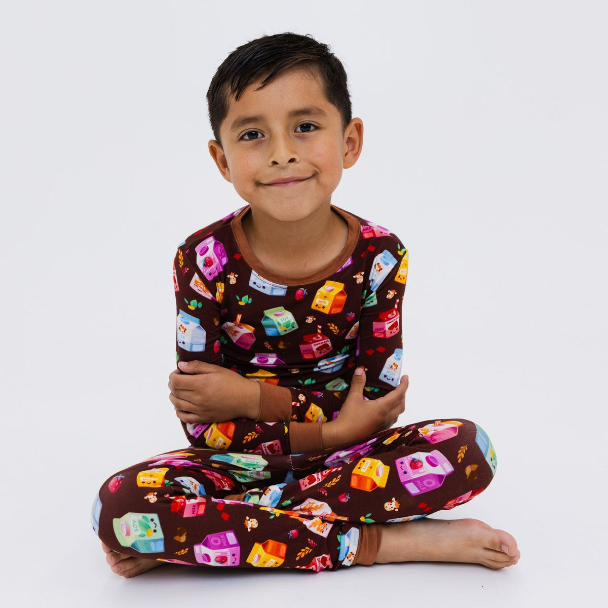 Child seated in Bam & Stitch All the Milks! Long Sleeve Pajamas.