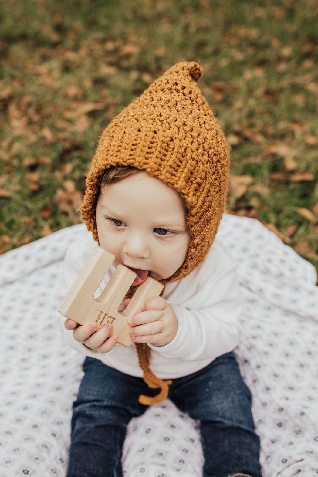 Lifestyle photo showing a wooden grasping toy with a child