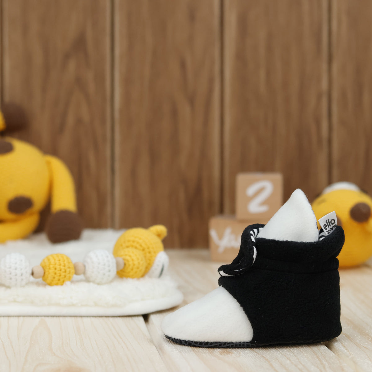 Single bootie on a tabletop, side view.