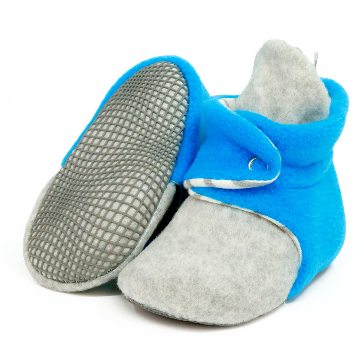Blue-and-gray fleece baby booties with striped lining and snap straps, with one sole facing the camera on a white background.