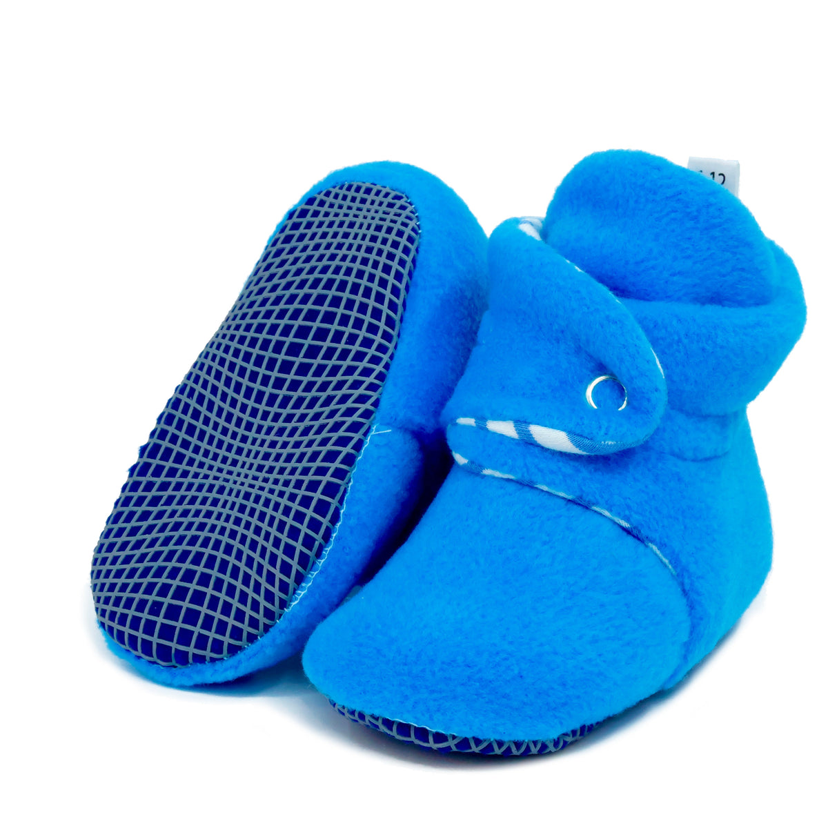 Bright blue fleece baby booties with striped lining and snap straps, with one sole facing the camera on a white background.
