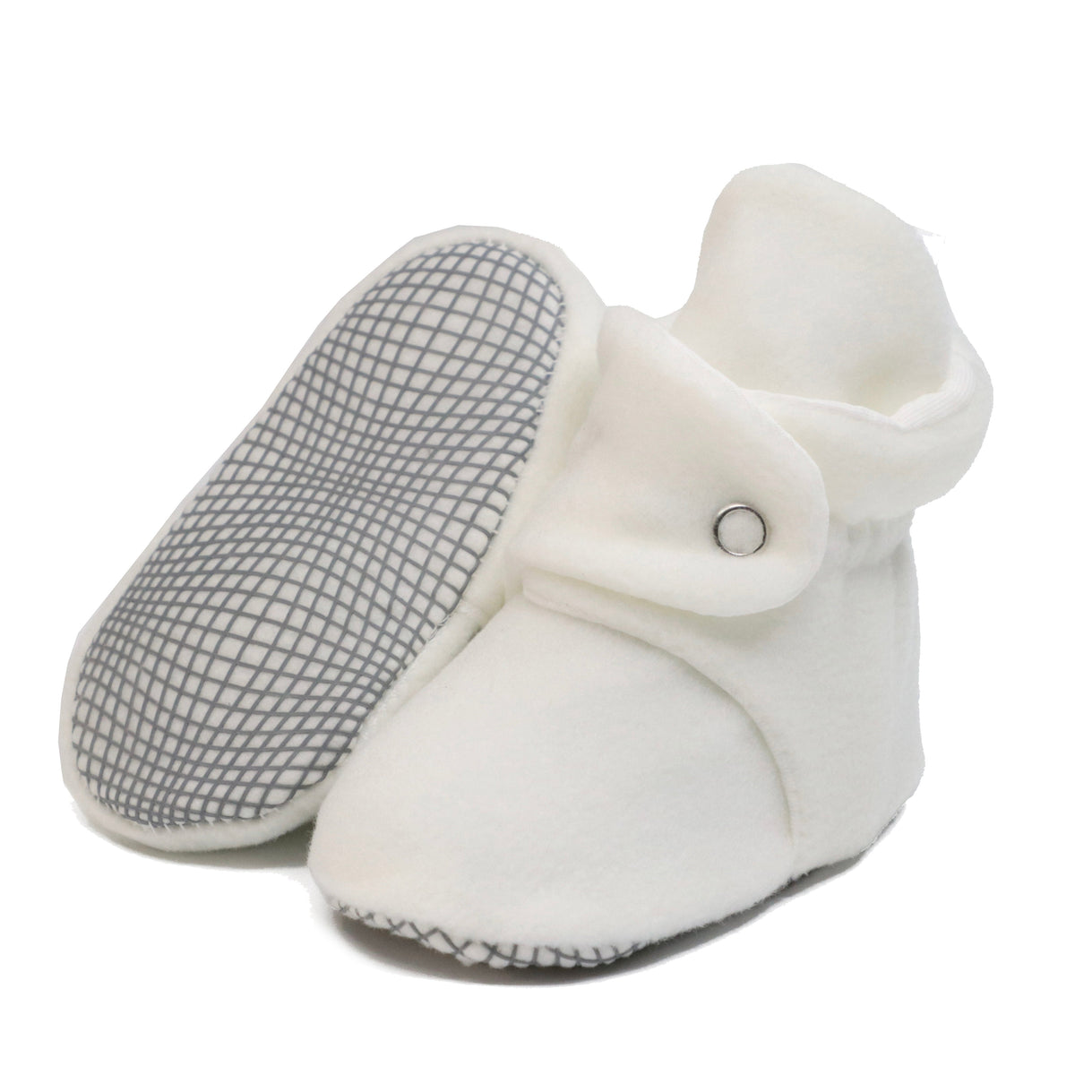 White fleece baby booties with snap straps, with one sole facing the camera on a white background.