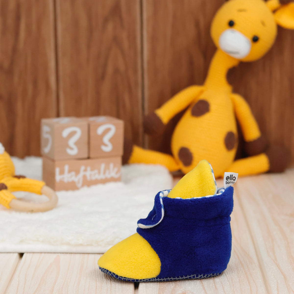 Single bootie on a tabletop, side view.