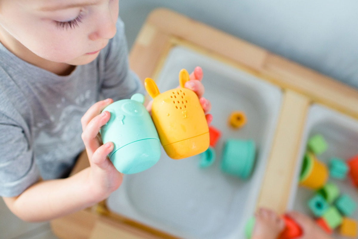 Lifestyle photo showing silicone bath toys with a child