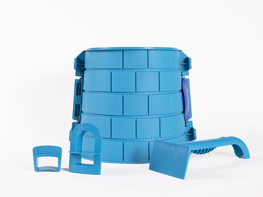 Blue Basic Tower split mold with a brick pattern, arched window cutter, rectangular battlement form and sculpting tool.