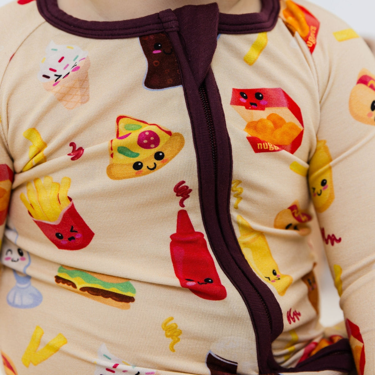 Close-up of the front zipper and fabric on Bam & Stitch Blissful Bites Convertible Romper.